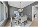 An elegant dining room features paneled walls, modern lighting, and bright light at 4800 Lakemont Dr, Raleigh, NC 27609
