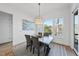 Stylish dining area with bright light from the large window and patterned area rug at 4800 Lakemont Dr, Raleigh, NC 27609
