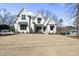 Beautiful modern farmhouse-style home with a manicured lawn and mature trees at 4800 Lakemont Dr, Raleigh, NC 27609