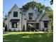 Charming two-story home boasts a modern farmhouse design, complemented by a lush green lawn and manicured landscaping at 4800 Lakemont Dr, Raleigh, NC 27609