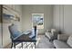 Elegant home office featuring board and batten walls, a glass-top desk, and ample natural light at 4800 Lakemont Dr, Raleigh, NC 27609