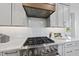 A modern kitchen features white cabinets, stainless appliances, and marble countertops at 4800 Lakemont Dr, Raleigh, NC 27609