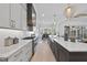 A modern kitchen with stainless appliances, an island sink, and open dining room at 4800 Lakemont Dr, Raleigh, NC 27609