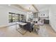 A spacious living room with a fireplace, exposed beams, and sliding doors to a porch at 4800 Lakemont Dr, Raleigh, NC 27609