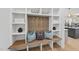 Charming mudroom boasting custom built-ins, bench seating, hooks, and stylish decor with a view into the kitchen at 4800 Lakemont Dr, Raleigh, NC 27609