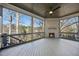 Relaxing outdoor porch with a cozy fireplace, ceiling fan, and scenic views of the surrounding landscape at 4800 Lakemont Dr, Raleigh, NC 27609