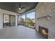 Inviting porch with a stone fireplace, ceiling fan, and access to a dining space with scenic backyard views at 4800 Lakemont Dr, Raleigh, NC 27609