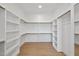 Spacious walk-in closet with ample shelving and rods for organized storage at 4800 Lakemont Dr, Raleigh, NC 27609