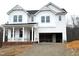 Two-story white house with a gray roof and brick foundation at 98 Claude Creek Dr, Smithfield, NC 27577