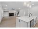 Open concept kitchen with island and white cabinets, overlooking living room at 114 Sanderway Dr, Chapel Hill, NC 27516