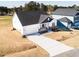 Aerial view of a new home featuring a covered front porch and a two-car garage on a spacious lot at 818 Barbour Farm Ln, Four Oaks, NC 27524