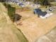 This is an aerial view of a white home and blue home near a golf course at 818 Barbour Farm Ln, Four Oaks, NC 27524