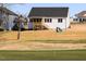 The backyard has green grass and a putting green with a flag in the distance at 818 Barbour Farm Ln, Four Oaks, NC 27524