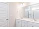 Spacious bathroom with dual vanities, quartz countertops, white cabinets, and a glass-enclosed shower at 818 Barbour Farm Ln, Four Oaks, NC 27524