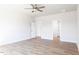 A bright bedroom featuring neutral paint, laminate floors, and two entryways at 818 Barbour Farm Ln, Four Oaks, NC 27524