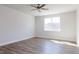 Bright bedroom with hardwood floors, a large window offering ample natural light, and neutral walls at 818 Barbour Farm Ln, Four Oaks, NC 27524