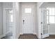 Bright entryway with wood floors, featuring a white front door, a glass panel door, and an open view at 818 Barbour Farm Ln, Four Oaks, NC 27524
