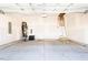 Spacious garage with concrete flooring, water heater, and ladder access to attic at 818 Barbour Farm Ln, Four Oaks, NC 27524