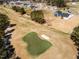 This is an aerial view of a golf course that has a sand trap and green at 818 Barbour Farm Ln, Four Oaks, NC 27524