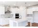 Modern kitchen with white cabinetry, quartz countertops, stainless steel appliances, and a center island at 818 Barbour Farm Ln, Four Oaks, NC 27524