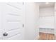Hallway view of bright mudroom featuring white shelving, cubbies, and hooks for storage at 818 Barbour Farm Ln, Four Oaks, NC 27524