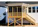 This is an exterior view of a home with a screened porch and wooden steps at 818 Barbour Farm Ln, Four Oaks, NC 27524