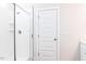Modern shower with white subway tile, a glass door, and built-in shelves for convenient storage at 818 Barbour Farm Ln, Four Oaks, NC 27524