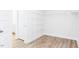 Walk-in closet featuring wood look flooring and white shelving at 818 Barbour Farm Ln, Four Oaks, NC 27524