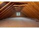 Large unfinished attic space with wood flooring and window at 7220 Dime Dr, Raleigh, NC 27606