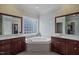Large bathroom with double vanities, soaking tub, and separate shower at 7220 Dime Dr, Raleigh, NC 27606