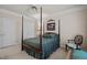 Serene bedroom with four-poster bed and double doors to closet at 7220 Dime Dr, Raleigh, NC 27606