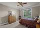 Bright bedroom with double bed and dresser, featuring large window at 7220 Dime Dr, Raleigh, NC 27606