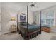 Bright bedroom with a four poster bed and window seat at 7220 Dime Dr, Raleigh, NC 27606