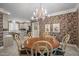 Bright dining room featuring a round table with seating for six and a floral wallpaper at 7220 Dime Dr, Raleigh, NC 27606