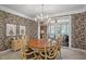 Elegant dining room with a round table, chandelier, and access to a screened porch at 7220 Dime Dr, Raleigh, NC 27606