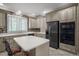 Modern kitchen with stainless steel appliances and an island with seating at 7220 Dime Dr, Raleigh, NC 27606