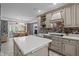 Spacious kitchen with an island, breakfast bar and view into the dining room at 7220 Dime Dr, Raleigh, NC 27606