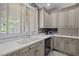 Kitchen features double sink, custom cabinetry and a view to the backyard at 7220 Dime Dr, Raleigh, NC 27606