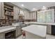 Well-equipped kitchen with custom cabinetry, a cooktop, and breakfast bar at 7220 Dime Dr, Raleigh, NC 27606