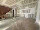 A basement living area with stairs leading to the upper floors and unfinished elements at 1101 Manchester, Raleigh, NC 27609