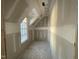 Unfinished bedroom with a window with angled ceiling and recessed lighting at 1101 Manchester, Raleigh, NC 27609