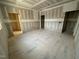 Spacious living room featuring primed walls, electrical box cutouts, and bare concrete floors at 1101 Manchester, Raleigh, NC 27609