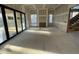 An unfinished living room featuring large glass doors and multiple windows for natural light at 1101 Manchester, Raleigh, NC 27609