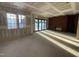 Large room with bright windows, sliding glass doors, a cozy brick fireplace, and concrete floors at 1101 Manchester, Raleigh, NC 27609