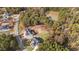 An aerial view of real estate surrounded by dense trees and a nearby pond at 2812 Theresa Eileen Way, Raleigh, NC 27603