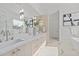 Bright bathroom featuring double vanity, marble floors and a full length mirror at 2812 Theresa Eileen Way, Raleigh, NC 27603