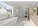 Bright bathroom with separate soaking tub and glass enclosed shower, across from double vanities at 2812 Theresa Eileen Way, Raleigh, NC 27603