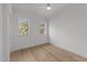 Empty bedroom features hardwood floors, neutral walls, and two windows at 2812 Theresa Eileen Way, Raleigh, NC 27603