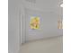 Bright bedroom with white walls, carpet, and windows offering scenic outdoor views at 2812 Theresa Eileen Way, Raleigh, NC 27603