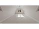 Bright attic bonus room with neutral carpet and natural light from a window at 2812 Theresa Eileen Way, Raleigh, NC 27603